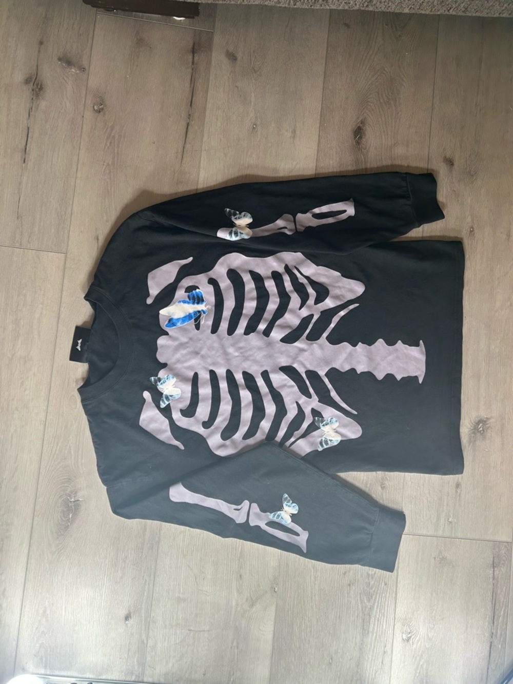 Black scale skeleton Graphic Long Sleeve Tee with Blue Butterfly Accents